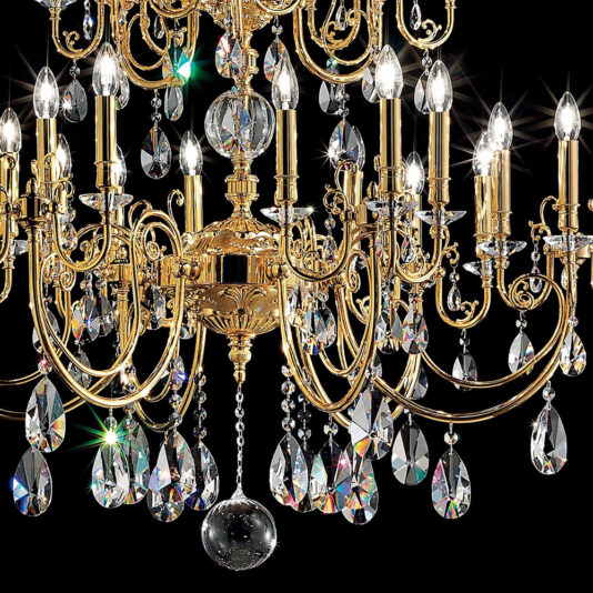 Classic Gold Transparent Chandelier The Classic Gold Transparent Chandelier, adorned with multiple candelabra-style bulbs and elaborate crystal pendants, emits a dazzling array of light. This intricately designed fixture stands out against a black background, with transparent teardrop-shaped ornaments reflecting prisms of color.