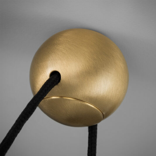A close-up image of the Contemporary Triple LED Pendant Light featuring a golden spherical design with a smooth, brushed texture. Two black cords pass through an opening in the sphere and hang down, showcasing its modern, minimalist aesthetic against a grey background.