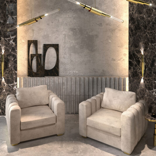 A modern living room features two **Exclusive Modern Armchairs** set against a textured concrete wall. The backdrop showcases dark marble panels, a corrugated metal strip, and abstract black and white art. Sleek linear pendant lights hang from the ceiling, enhancing the contemporary ambiance.