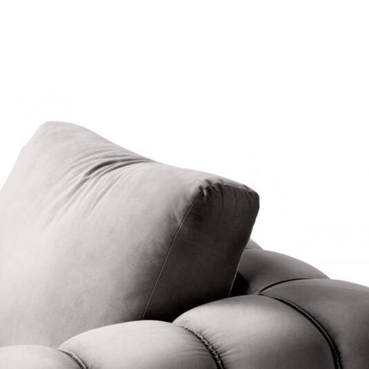 A close-up view of the Exclusive Modern Armchair showcases its luxurious, grey tufted design with a generously padded back cushion. The velvet-like fabric and deep buttoned diamond tufting contribute to the elegant and comfortable aesthetic of this sophisticated furniture piece.