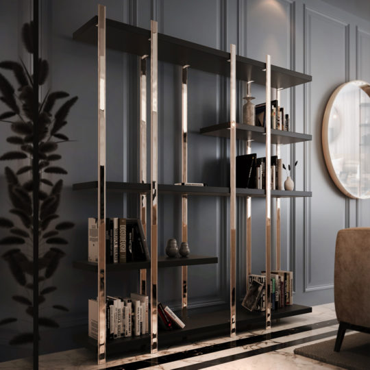 A sleek modern room featuring a Large Contemporary Open Bookcase in black and gold, filled with books and decorative items. The wall is paneled in a soft blue-gray color. A round mirror reflects light, adding depth, and a beige armchair sits nearby. A plant silhouette is visible in the foreground.