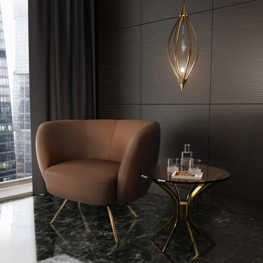A modern, elegantly designed room features a Modern Leather Tub Armchair in brown leather with gold legs, paired with a black marble side table. The table holds a glass water jug, two glasses, and a small plate of cookies. A gold pendant light fixture hangs on the dark paneled wall behind.