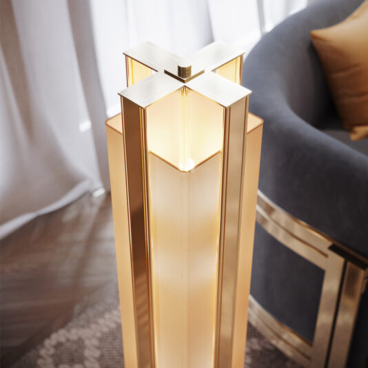 A close-up of the Modern Marble Floor Lamp reveals its elegant, contemporary design featuring a sleek, gold-colored rectangular frame. The lamp emits a warm light from its top, casting a soft glow. Positioned next to a gray sofa adorned with a gold accent and accompanied by a light brown pillow, the room is enhanced with light curtains.