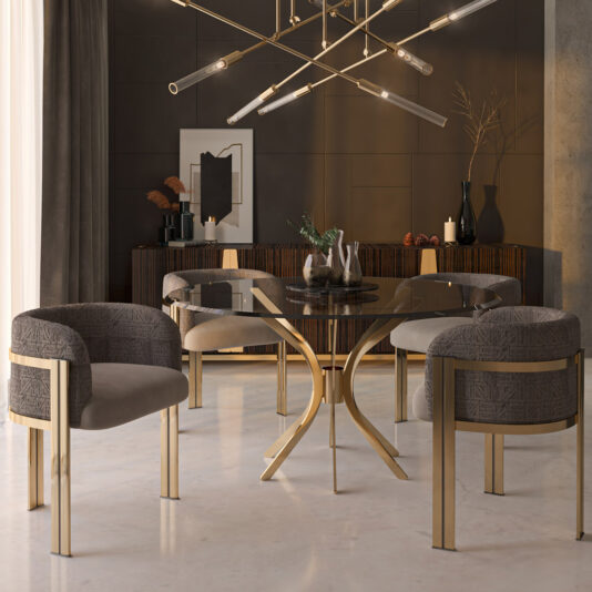 The Modern Round Glass Dining Set defines the dining room, featuring a table with gold legs and four grey upholstered chairs with gold accents. A geometric chandelier overhead illuminates the space, while a sideboard in the background is adorned with decor items and framed art.