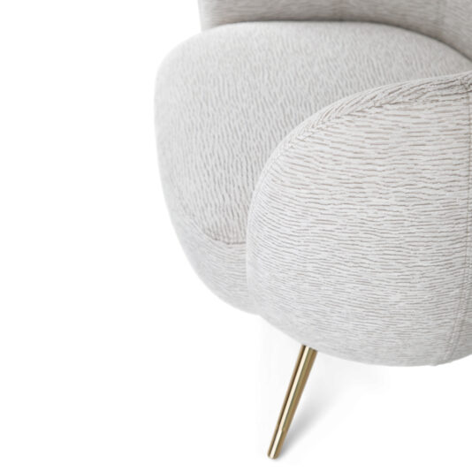 Close-up of the Modern Tub Armchair showcasing its white and light grey textured fabric. This chair features curved, cushioned armrests and a golden, tapered metal leg. The fabric resembles a subtle animal print or abstract ripples.