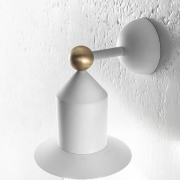 The Modern White LED Wall Light features a conical shade, a gold sphere accent at the top, and a cylindrical base. It is mounted on a white textured wall, creating a sleek, minimalist aesthetic.