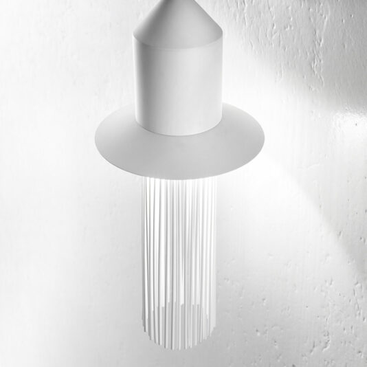 A Modern White LED Wall Light hangs from the ceiling against a white textured wall. Featuring a conical top with a wide circular brim and multiple thin, vertical elements dangling gracefully, this contemporary design creates an elegantly striking visual effect.