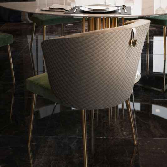 The Round Marble Dining Table and Chairs Set, featuring luxurious dining chairs with quilted backrests and gold legs, is adorned with elegant tableware. This refined setup reflects on the glossy dark floor, enhancing the sophisticated ambiance of the space.