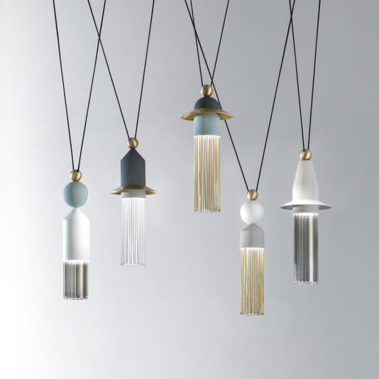 The Set Of Modern Pendant Lights boasts unique designs, incorporating gold, silver, and white elements along with decorative fringe-like accents. Hanging from black cords against a plain, light-colored background, this set of five lights brings a contemporary flair to any space.