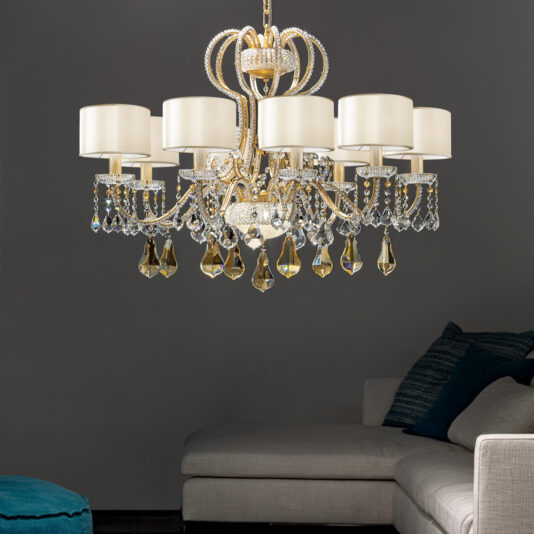 Classic Crystal Chandelier With Shades The Classic Crystal Chandelier With Shades, featuring multiple candle-shaped lights adorned with crystals, hangs from the ceiling in a modern living room with a grey sofa and teal cushions. The dark background wall enhances the elegant lighting fixture's glow.