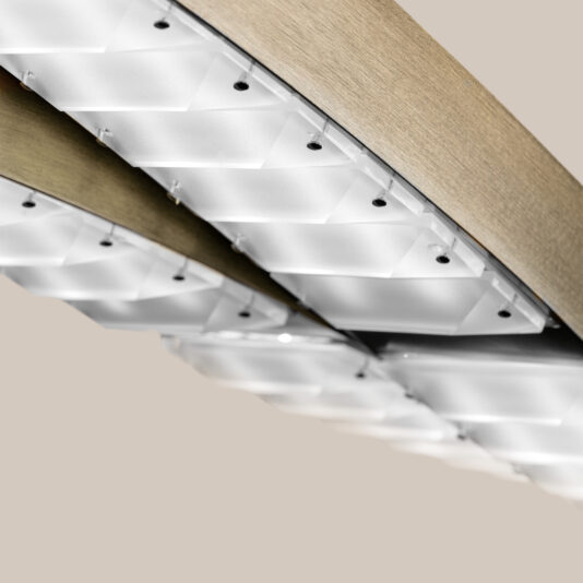 Contemporary Linear Chandelier A close-up reveals the Contemporary Linear Chandelier, showcasing diamond-shaped translucent panels in a geometric design, set against a neutral background.