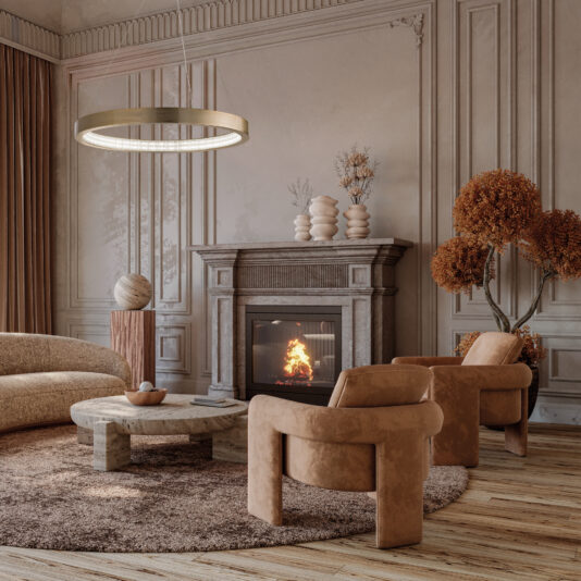 A cozy living room features a lit fireplace, beige armchairs, and a rounded sofa. A wooden coffee table rests on a brown rug while the Contemporary Round Chandelier shines warmly above. Autumn foliage adds warmth next to the fireplace.