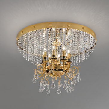 Classic Ceiling Light With Crystal Pendants The Classic Ceiling Light With Crystal Pendants is a luxurious gold chandelier featuring five candle-shaped lights adorned with dangling crystal beads and prisms. Attached to a large gold ceiling mount, additional crystals hang from the fixture, creating a sparkling effect.