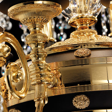 Classic Ceiling Light With Crystal Pendants Close-up of the Classic Ceiling Light With Crystal Pendants, showcasing its ornate gold chandelier with intricate detailing. This classic ceiling light features elaborately designed candle holders and a mix of polished and brushed gold surfaces, beautifully reflecting light.