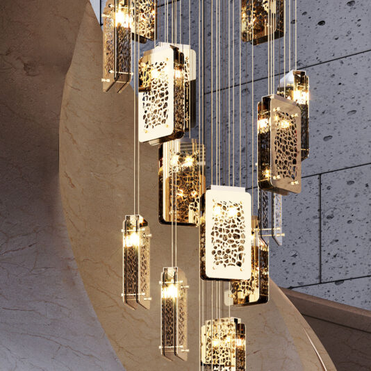 The Contemporary Stairwell Chandelier showcases several rectangular, perforated gold frames suspended at different heights. It bathes the area in a warm light, accentuating the textured concrete wall and the elegant curved marble structure in the background.