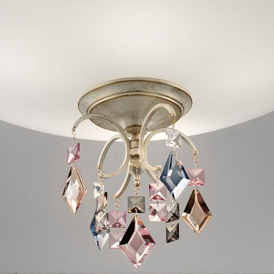 The Elegant Crystal Pendant Ceiling Light boasts a metallic base and an exquisite ornate design. It features dangling crystal ornaments in diverse geometric shapes and colors such as pink, blue, and clear. The light is softly diffused through a frosted white dome positioned above the crystals.