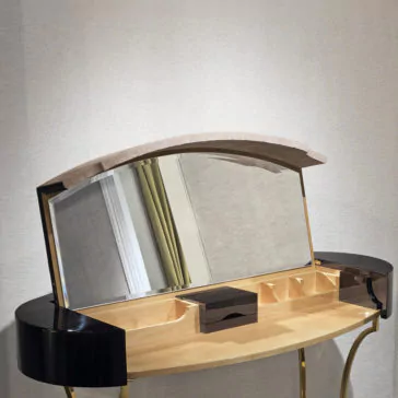 Classic Ebony Dressing Table The Classic Ebony Dressing Table is a sleek and sophisticated piece, showcasing a timeless ebony finish accented with a gold frame. It features an arched mirror that is hinged and partially open, revealing multiple storage compartments within the wooden tabletop. This elegant dressing table also includes black curved side panels and stands gracefully against a neutral wall.