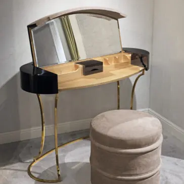 Classic Ebony Dressing Table The Classic Ebony Dressing Table showcases a modern design with a wooden top, curvy legs, and a large mirror. It includes multiple compartments, such as a central drawer. Complementing the table is a matching round, cushioned stool. The setup is elegantly placed in a corner with neutral-toned carpeting.