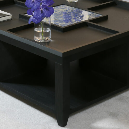 The Luxury Square Coffee Table showcases a sophisticated dark wooden grid design with a sleek glass centerpiece. Atop the table rests a vase filled with vibrant purple flowers, enhancing its elegance. The table stands gracefully on a light grey carpet.