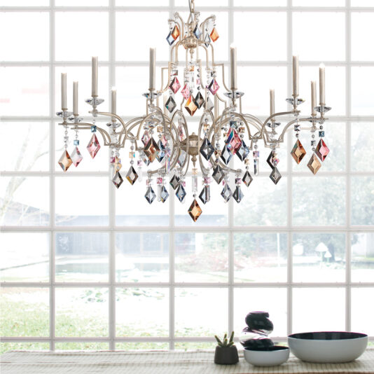 Luxury Crystal Pendant Chandelier An elegant Luxury Crystal Pendant Chandelier with colorful crystal prisms hangs above a dining table adorned with potted plants and modern dishware. Large grid windows behind it offer a view of a serene yard complete with trees and a pond.