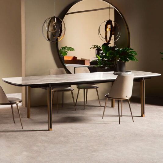 Modern Rectangular Marble Dining Table A modern dining room showcases the Modern Rectangular Marble Dining Table, featuring a polished surface and minimalist design. Chic chairs surround the table, enhancing its sleek appeal. A large, round mirror and pendant lights add elegance to the space, while potted green plants bring a touch of nature to the sophisticated setting.