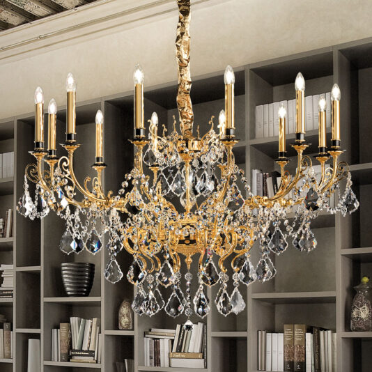 An Opulent Crystal Pendant Chandelier, featuring intricate gold details and multiple candle-shaped lights, hangs elegantly from the ceiling. It is set against a backdrop of bookshelves filled with books and other decorative items.