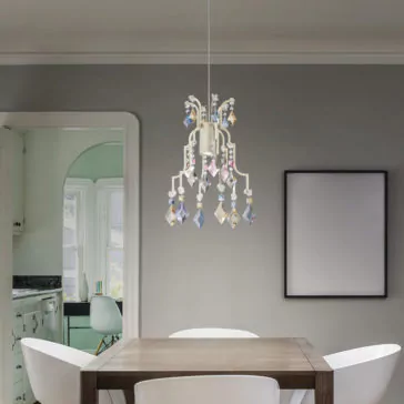 Traditional Crystal Pendant Chandelier A modern dining room showcases a wooden table paired with white chairs. The space is elegantly accented by a Traditional Crystal Pendant Chandelier, adorned with colorful ornaments. An empty picture frame decorates the wall, while a doorway opens to an adjacent room themed in green.