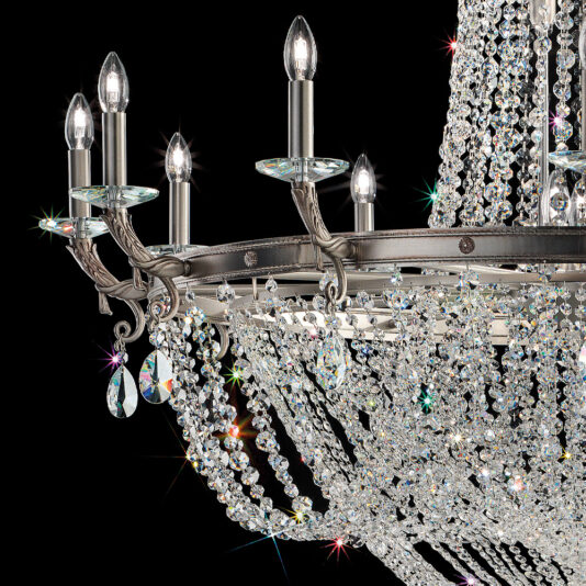 Classic Antiqued Chrome Crystal Chandelier The Classic Antiqued Chrome Crystal Chandelier with multiple candle-like bulbs and intricate crystal decorations hangs against a black background. Featuring cascading strands of sparkling crystals, the chrome structure creates a dazzling display.