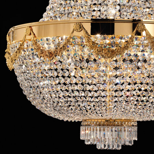 Classic Crystal Drop Empire Chandelier Close-up of the luxurious Classic Crystal Drop Empire Chandelier showcasing its intricate gold detailing and numerous sparkling crystals elegantly suspended from a gold frame, shining brilliantly against a dark background.