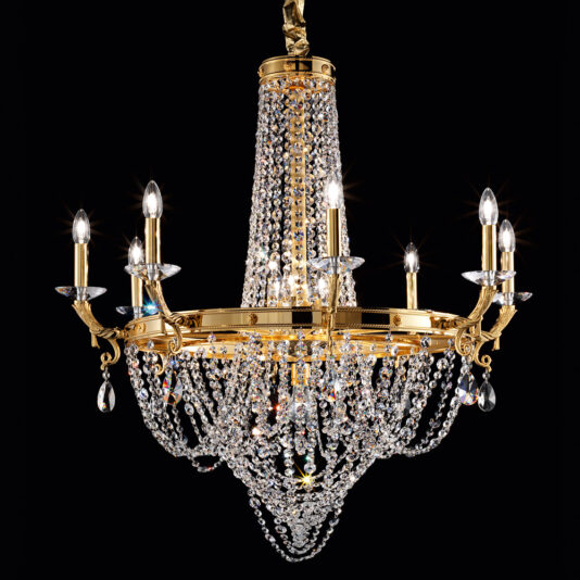 The Classic Crystal Drop Chandelier is a luxurious lighting fixture adorned with gold accents. Its multiple arms hold candle-shaped bulbs, and its design features numerous strands of hanging crystals that capture and reflect light beautifully, creating a sparkling effect against a black background.