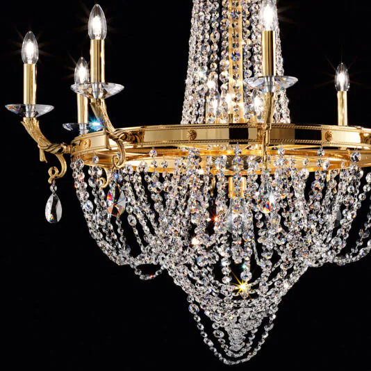 Classic Crystal Drop Chandelier The exquisite Classic Crystal Drop Chandelier features an array of sparkling crystal beads draped in elaborate strands. Its multiple candle-like bulbs emit a warm glow, accentuating the intricate design and brilliance of the crystals against a black backdrop.