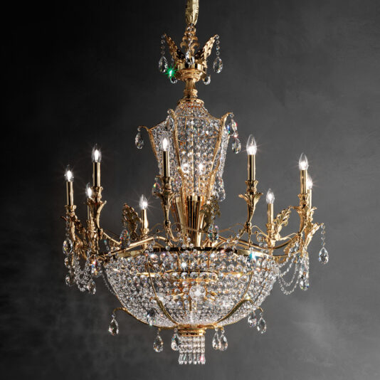 An opulent **Classic Gold Plated Crystal Empire Chandelier** adorns the space, boasting multiple arms, each showcasing a lit candle-shaped bulb. The chandelier is intricately designed with hanging crystal ornaments that gleam brilliantly against the dark background, exuding a grand and elegant aura.