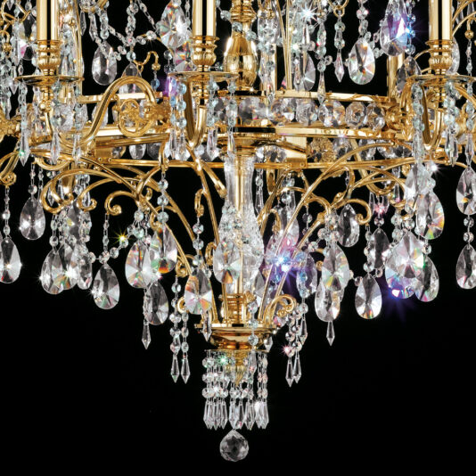 Classic Gold Plated Crystal Pendant Chandelier A close-up of the Classic Gold Plated Crystal Pendant Chandelier, adorned with numerous sparkling crystal prisms and beads, reflecting light beautifully against a black background. The intricate design includes hanging teardrop-shaped crystals, adding to its opulent appearance.