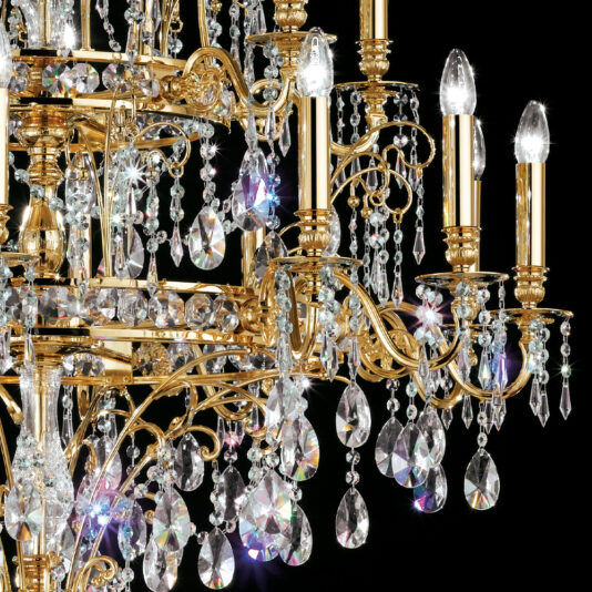 Classic Gold Plated Crystal Pendant Chandelier A close-up of the Classic Gold Plated Crystal Pendant Chandelier reveals its luxurious design, featuring multiple ornate golden arms, dangling crystal prisms, and lit candle-style bulbs. The crystals catch the light beautifully, creating a sparkling effect against a black background.