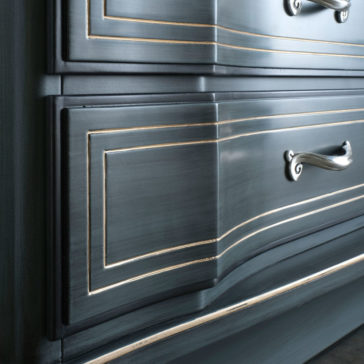 Classic Style Italian Chest Of Drawers Close-up of the Classic Style Italian Chest Of Drawers in dark blue, showcasing a distressed finish with silver handles and gold detailing on the edges. The ornate, vintage-inspired design emphasizes the craftsmanship and elegance characteristic of traditional Italian furniture.