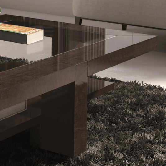 In a modern living room, the focal point is the Contemporary Rectangular Coffee Table With Glass Top, featuring dark wooden legs and a lower shelf where a book rests. The plush floor is covered with a dark shag rug, while part of a light-colored couch can be seen in the background.