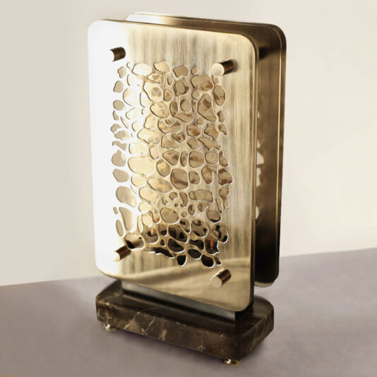 Contemporary Marble Table Lamp The Contemporary Marble Table Lamp boasts a sophisticated and artistic vibe with its sleek, abstract metal design. It features two rectangular metal sheets adorned with organic cutouts, elegantly mounted on a dark, polished marble base.