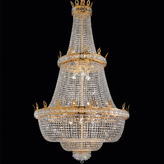 The Deluxe Crystal Drop Empire Chandelier boasts intricate crystal beading and gold accents, showcasing a tiered design with multiple layers. This elegant chandelier features a wide base that tapers to a smaller top, creating an opulent display against a black background.