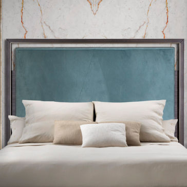 Elegant Metal Frame Bed The Elegant Metal Frame Bed boasts a stylish blend of modernity and elegance with its sleek metal construction and padded blue headboard. Positioned against a white marble-patterned wall, the bed is beautifully adorned with five cushions in various shades of beige, white, and brown, each meticulously arranged for a tidy appearance. The overall ambiance exudes both coziness and contemporary charm.