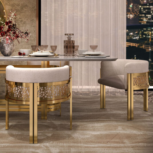 A modern dining room with a luxurious setup. The table boasts a white marble top and is surrounded by four Exclusive Curved Dining Chairs, which feature intricate gold-framed patterns on the sides. Sheer curtains adorn the background, revealing a stunning cityscape at night.