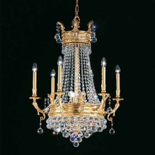 The Crystal Drop Empire Chandelier, adorned with cascading crystal beads and intricate detailing, exudes luxury. This gold-plated masterpiece boasts six candle-style light fixtures that add a touch of elegant and classic charm against any dark background, highlighting its brilliance.