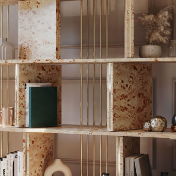 Large Modern Art Deco Style Bookcase A close-up of the Large Modern Art Deco Style Bookcase, featuring elegant marble shelves supported by chic gold metal bars. The shelves are adorned with various decorative items such as books, vases, a ceramic sculpture, and small ornamental objects. A dried plant arrangement is also visible.