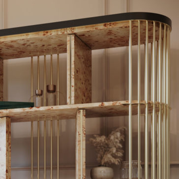 Large Modern Art Deco Style Bookcase A close-up of the Large Modern Art Deco Style Bookcase, showcasing its wooden shelves with a speckled pattern and gold-finished vertical metal rods that support the structure. The bookcase displays a green book, two small glass vases, and a pot with dried pampas grass.