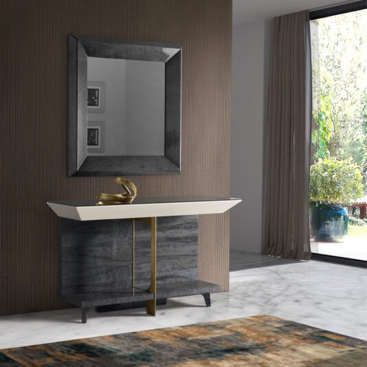 Modern Veneer Console Table A modern interior with the sleek Modern Veneer Console Table featuring a golden faucet, a large rectangular mirror with a dark frame, and a textured wall. The space includes a marble floor, a patterned rug, and a large window with curtains offering a view of greenery outside.
