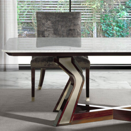 The Luxury Marble Top Dining Table boasts a contemporary design with a sophisticated marble surface and a chic, geometric metal and wood base. An elegantly upholstered dining chair, covered in dark, textured fabric, is positioned at the table. The room is complemented by large windows that provide a serene view of the lush greenery outside.