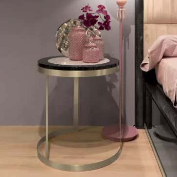 Luxury Modern Upholstered Bed A stylish bedside table is adorned with decorative pink vases, a silver tray with a textured surface, and a bouquet of purple flowers. The table features a gold frame and black top, enhancing the luxury modern vibe against the soft pink bedset and gray wall of the Luxury Modern Upholstered Bed.