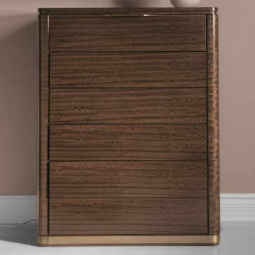 The Modern Tallboy Chest Of Drawers is a sophisticated piece, standing tall and crafted from wood with a sleek, glossy brown finish. It features five horizontal drawers, rounded edges, and rests gracefully on a light-colored floor against a muted pink wall. The drawer fronts highlight subtle, natural wood grain patterns.