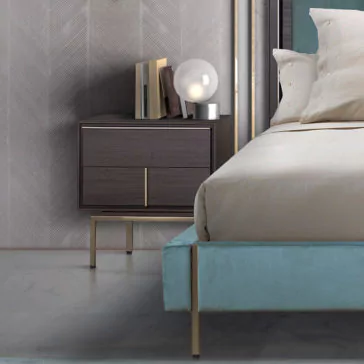 Modern Elegant Bedside Table A modern bedroom scene featuring a Modern Elegant Bedside Table with two minimalist wooden drawers, books, and a spherical lamp on top. Next to it is a neatly made bed with beige sheets and pillows. The wall behind has a textured pattern, and the floor is smooth and light-colored.
