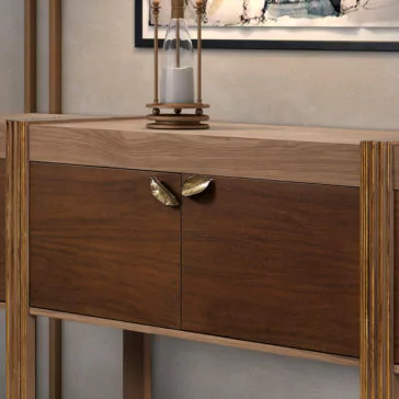 Modern Elegant Sideboard A detailed close-up of the Modern Elegant Sideboard featuring two doors adorned with leaf-shaped bronze handles. The top of the cabinet is embellished with a decorative hourglass containing white sand. The backdrop includes a framed abstract painting on the wall.