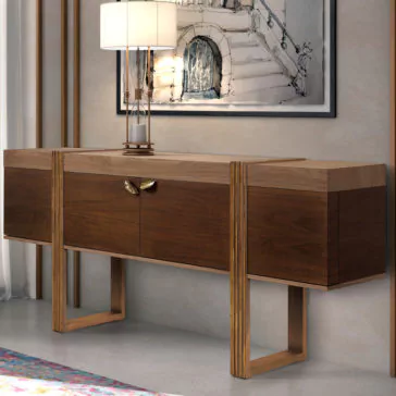 Modern Elegant Sideboard A Modern Elegant Sideboard with a smooth finish showcasing two cabinets and a central section adorned with golden handles. Atop the sideboard sits a contemporary lamp with a white shade, while a framed architectural drawing is mounted on the wall above. The neutral gray flooring completes the sophisticated look.